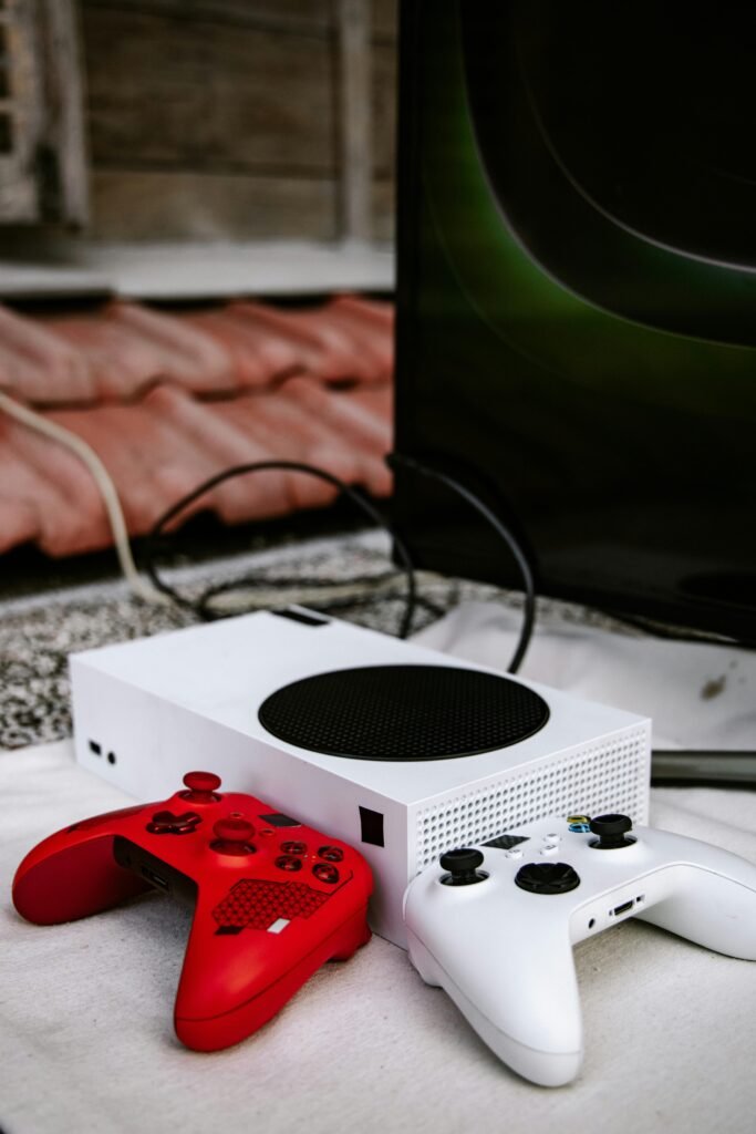 Xbox game console setup with vibrant red and white controllers, emphasizing wireless gaming.