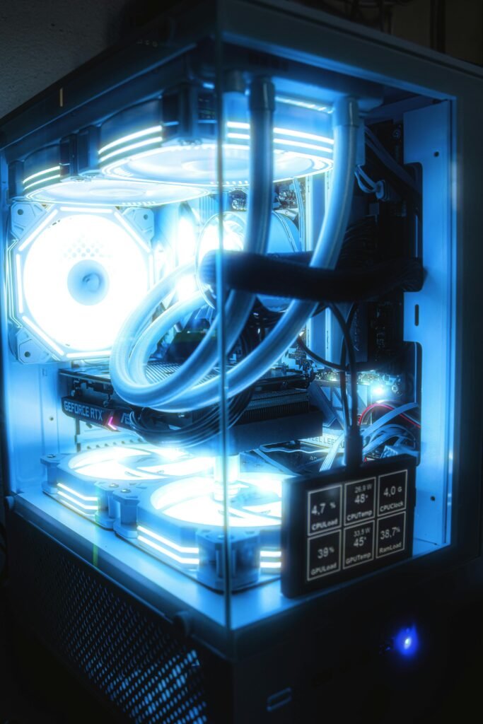 High-performance gaming PC setup featuring blue LED lighting and advanced cooling system.