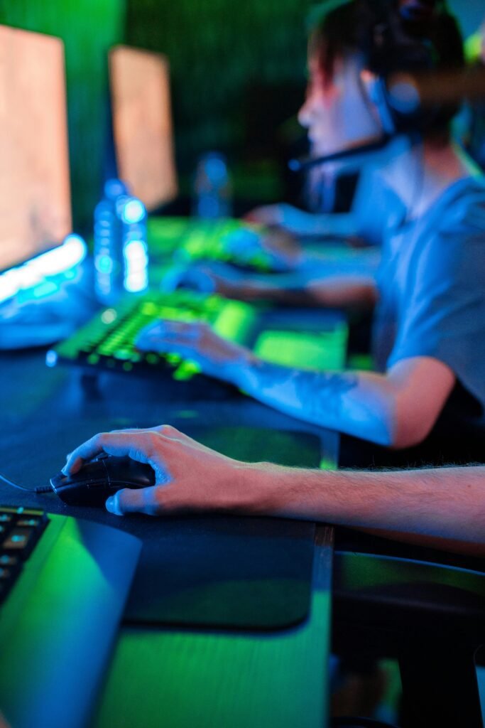 Team of gamers focused on screens during an intense online gaming session.