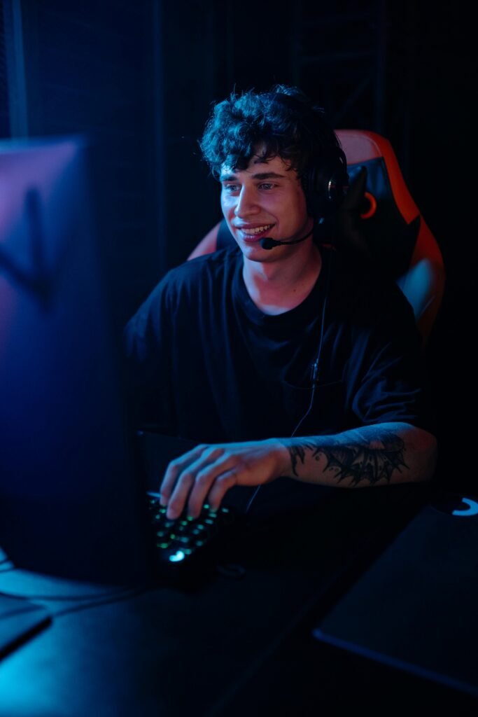 Energetic young man engaged in e-sports gaming with headphones.